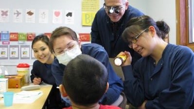 dental therapists talking to a young kid
